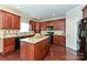 Kitchen area highlighting a granite island, cabinetry, and dark appliances set against warm wood floors at 258 Lagoda Dr, Locust, NC 28097