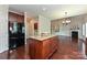 Spacious kitchen island with granite countertop adjacent to a cozy living area and black stainless refrigerator at 258 Lagoda Dr, Locust, NC 28097