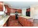 Well-equipped kitchen includes an island, granite countertops, dark wood cabinets, and stainless appliances at 258 Lagoda Dr, Locust, NC 28097