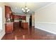 Bright kitchen with dark wood cabinets, granite counters, a central island, and hardwood flooring at 258 Lagoda Dr, Locust, NC 28097