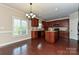 Eat-in kitchen showcases wooden cabinets, granite countertops, an island, and a view of the outdoors at 258 Lagoda Dr, Locust, NC 28097