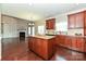 Kitchen with a central island featuring granite countertops and seamless transition to a combined living space at 258 Lagoda Dr, Locust, NC 28097