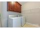 Functional laundry room with ample cabinet storage and modern washer and dryer units at 258 Lagoda Dr, Locust, NC 28097