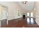 Bright living room with wood floors, vaulted ceiling, fireplace, and custom built-in shelving at 258 Lagoda Dr, Locust, NC 28097