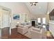 Staged living room with vaulted ceiling, hardwood flooring, built-in shelving, and a fireplace at 258 Lagoda Dr, Locust, NC 28097