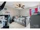 Comfortable bedroom featuring unique gray furniture and a well lit desk with computer and gaming equipment at 2745 River Meadows Ct, Lincolnton, NC 28092