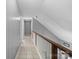 Second-story hallway with tiled floor and wood handrail at 2745 River Meadows Ct, Lincolnton, NC 28092