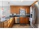 Well-lit kitchen featuring stainless steel appliances, wood cabinets and tile floor at 2745 River Meadows Ct, Lincolnton, NC 28092