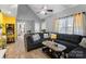 Comfortable living room with modern sectional sofa, vaulted ceilings, and wood-look flooring at 2745 River Meadows Ct, Lincolnton, NC 28092