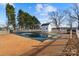 Backyard pool is winterized and surrounded by a white picket fence and a small pool house at 2745 River Meadows Ct, Lincolnton, NC 28092