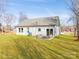 Well-maintained lawn and outdoor seating area add charm to the backyard. Windows look into home at 2853 W Zion Church Rd, Shelby, NC 28150