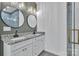 Stylish bathroom featuring double granite vanity, modern lighting, and round mirrors at 2853 W Zion Church Rd, Shelby, NC 28150