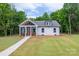 Charming cottage-style home featuring a welcoming front porch and well-manicured lawn at 2853 W Zion Church Rd, Shelby, NC 28150
