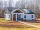 The exterior of the home is enhanced by a covered front porch, green and white siding, and new landscaping at 2853 W Zion Church Rd, Shelby, NC 28150