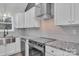 Well-appointed kitchen showcasing stainless steel appliances, stylish backsplash, and granite countertops at 2853 W Zion Church Rd, Shelby, NC 28150
