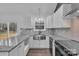 Bright kitchen featuring custom cabinets, stainless steel sink, stone countertops and stainless steel appliances at 2853 W Zion Church Rd, Shelby, NC 28150