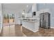 Well-lit kitchen with granite countertops, stainless steel appliances, and sliding door access to the backyard at 2855 W Zion Church Rd, Shelby, NC 28150