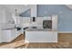 Modern kitchen boasts white cabinetry, granite countertops, an island, and stainless steel appliances at 2855 W Zion Church Rd, Shelby, NC 28150
