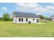 View of home's rear exterior showing a lush yard, patio area, and energy-efficient windows at 2867 W Zion Church Rd, Shelby, NC 28150