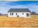 Back exterior of a white home with a dark roof and small patio at 2867 W Zion Church Rd, Shelby, NC 28150