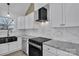 Well-equipped kitchen featuring granite countertops, stainless appliances, white cabinets, and plenty of counter space at 2867 W Zion Church Rd, Shelby, NC 28150