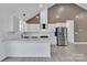 Bright kitchen boasts white cabinets, modern stainless steel appliances, and speckled granite countertops at 2867 W Zion Church Rd, Shelby, NC 28150