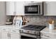 Close-up of a gourmet kitchen with stainless steel appliances, sleek countertops, and modern backsplash at 3158 Finchborough Ct # 256, Charlotte, NC 28269