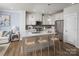 Stylish kitchen featuring white cabinets, stainless steel appliances, a center island, and hardwood floors at 3158 Finchborough Ct # 256, Charlotte, NC 28269