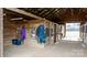 Barn interior featuring horse stalls, storage shelves, and well-maintained wooden walls at 3427 Joe Johnson Rd, Catawba, NC 28609