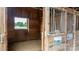 Clean horse stall with a window, metal bars, and wooden construction at 3427 Joe Johnson Rd, Catawba, NC 28609