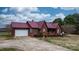 Charming home showcasing a red metal roof, wood siding, covered porch and an attached two-car garage at 3427 Joe Johnson Rd, Catawba, NC 28609