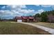 Exterior home view featuring a red metal roof, long driveway and an attached two-car garage at 3427 Joe Johnson Rd, Catawba, NC 28609
