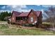 Charming exterior home view with a covered porch, wood siding, and manicured landscaping at 3427 Joe Johnson Rd, Catawba, NC 28609