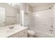 Bright bathroom with a white sink vanity, toilet, and shower/tub combination with tiled surround at 3610 Melrose Cottage Dr, Matthews, NC 28105