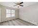 Inviting bedroom features a ceiling fan and carpet, complemented by two windows and a closet at 3610 Melrose Cottage Dr, Matthews, NC 28105