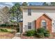 Close-up of a townhome featuring a brick facade and well-maintained landscaping at 3610 Melrose Cottage Dr, Matthews, NC 28105