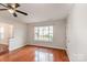 Cozy living area with gleaming hardwood floors and large window at 3610 Melrose Cottage Dr, Matthews, NC 28105