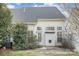 Back exterior with a small concrete patio and lush foliage, great for relaxing at 3822 Carl Parmer Dr, Harrisburg, NC 28075