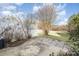 Backyard with a white fence, green grass, some plants, and a small concrete area at 3822 Carl Parmer Dr, Harrisburg, NC 28075