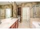 The primary bathroom features double sinks, a soaking tub, a glass shower, and a large walk-in closet at 3822 Carl Parmer Dr, Harrisburg, NC 28075