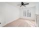 A bright, carpeted bedroom with plantation shutters and a modern ceiling fan at 3822 Carl Parmer Dr, Harrisburg, NC 28075