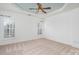 Spacious bedroom featuring a trey ceiling, a ceiling fan, neutral carpet, and plantation shutters at 3822 Carl Parmer Dr, Harrisburg, NC 28075