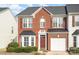 Charming brick front exterior featuring a garage and well-manicured landscaping at 3822 Carl Parmer Dr, Harrisburg, NC 28075
