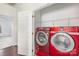 This laundry room includes a side-by-side red washer and dryer at 3822 Carl Parmer Dr, Harrisburg, NC 28075