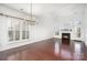 Open living room with wood floors, white walls, and a fireplace at 3822 Carl Parmer Dr, Harrisburg, NC 28075