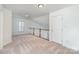 Bright upstairs loft with neutral carpet and a door to a bedroom or closet at 3822 Carl Parmer Dr, Harrisburg, NC 28075