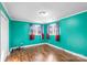 Bedroom featuring teal walls, wood-look floors, and two windows with patterned curtains at 41 Fleetwood Sw Dr # 44, Concord, NC 28027