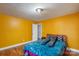 Bright bedroom featuring hardwood floors, yellow painted walls, and a comfortable-looking bed at 41 Fleetwood Sw Dr # 44, Concord, NC 28027