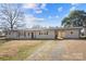 A one-story home showcasing a driveway and an open carport at 41 Fleetwood Sw Dr # 44, Concord, NC 28027
