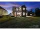 Large backyard featuring a screened porch, concrete patio, and well-maintained lawn at 416 Clemson Tree Ln, Lake Wylie, SC 29710